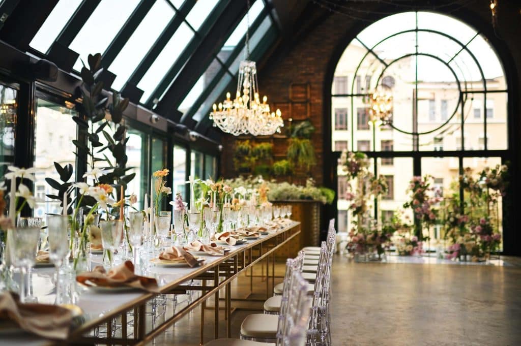 How Much Does Wedding Wire Cost for Wedding Venues? (And Is It Actually Worth It?) 1 Elegant wedding reception setup with long table, chandeliers, and floral arrangements, often used in listings when comparing how much does wedding wire cost