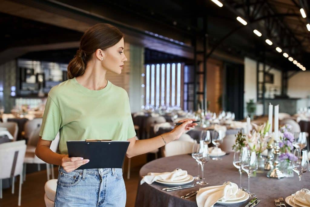 Is WeddingWire Worth It? A Guide for Wedding Venues 7 A wedding planner with a clip board contemplating is weddingwire worth it?
