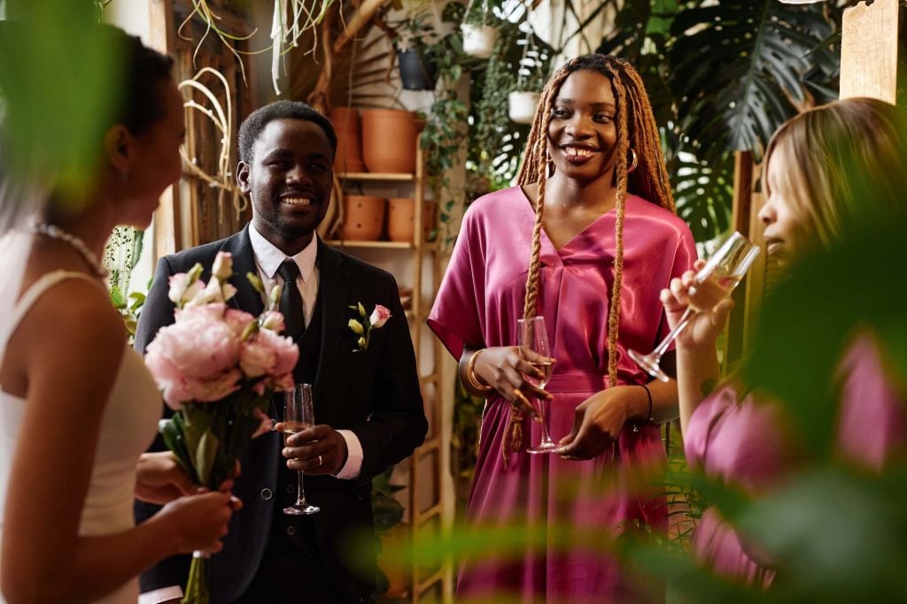 Wedding Venue Off Season Booking Strategy: Mid-Week + Shoulder-Season Plays 3 Small wedding group toasting together at an intimate indoor venue, ideal for wedding venue off season booking strategy
